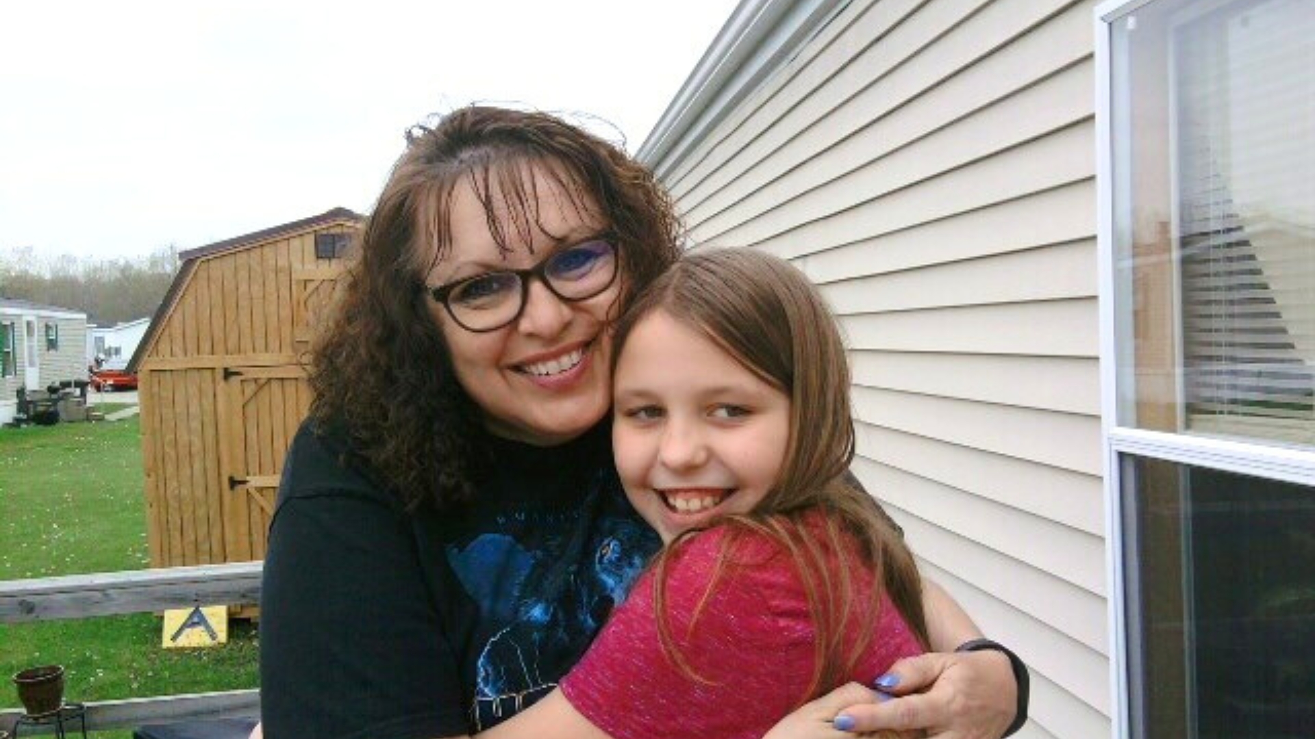 Big Sister Briana and Little Sister Makia share a hug  in 2016.