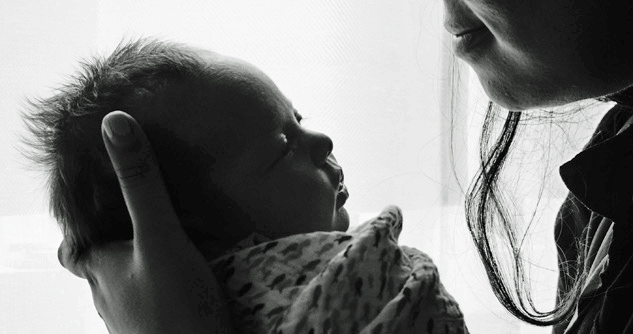 Close up of Newborn baby held by woman