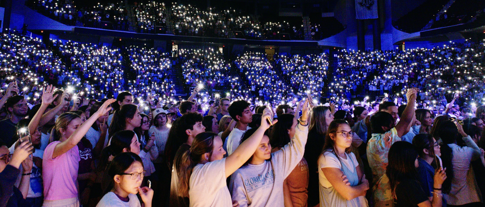 Students holding up their cell phones