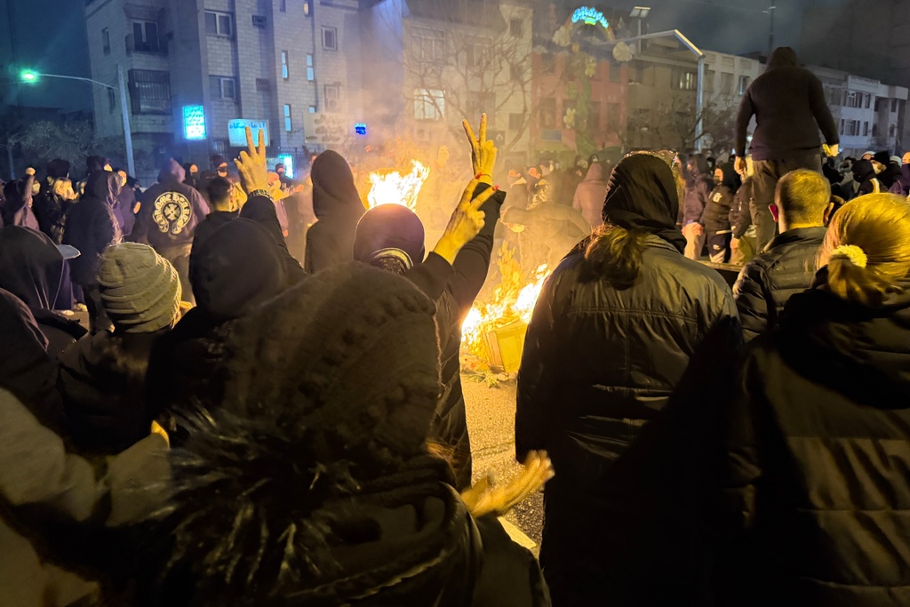Iranians attend an anti-government protest in Tehran, Iran, Friday, Jan. 9, 2026.