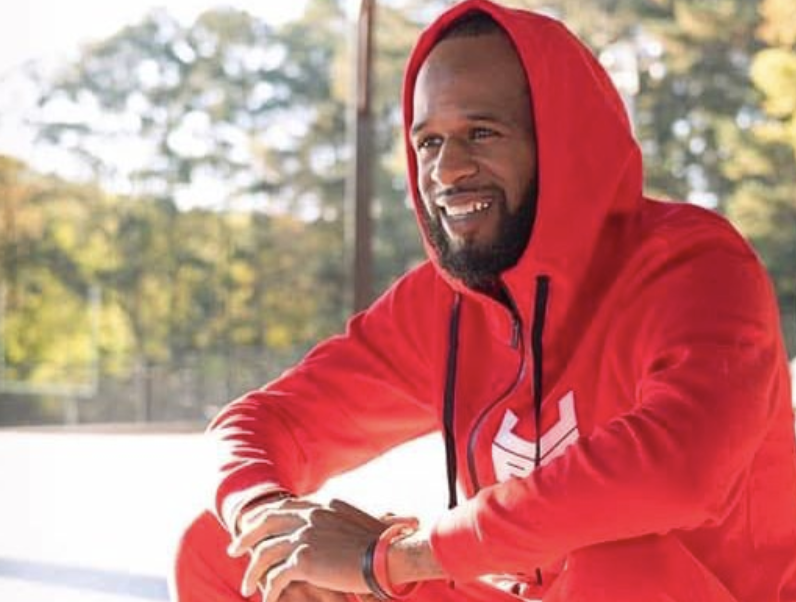 Young man in a red athletic sweatshirt, outside