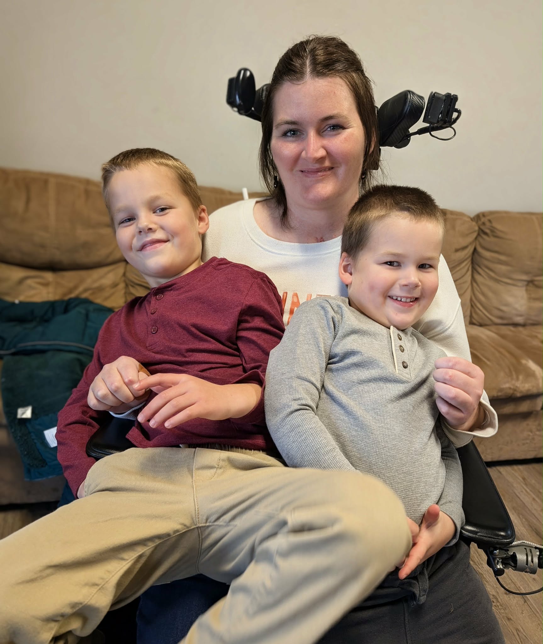 Madison sitting and smiling with her two sons, Miles and Miller