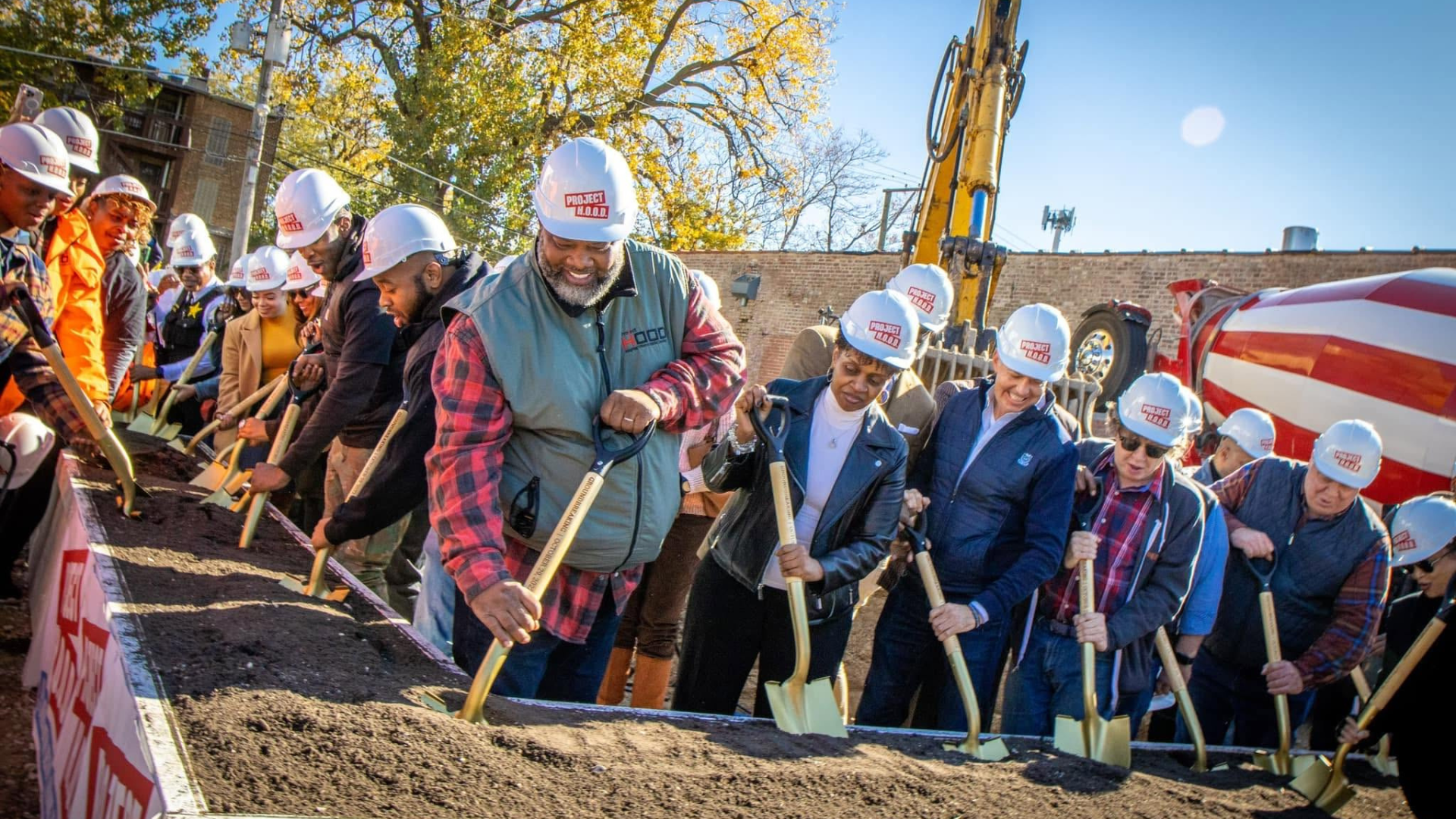Pastor Corey Brooks (front) and Project HOOD leaders at the groundbreaking for the organization