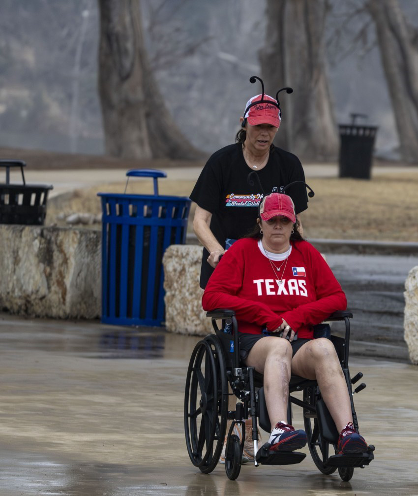 Joan Cortez being pushed in a local 5K run by her friend Laura.
