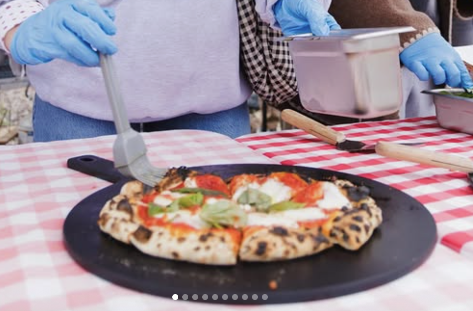 Wood-fired pizza on a red and white checkered tablecloth