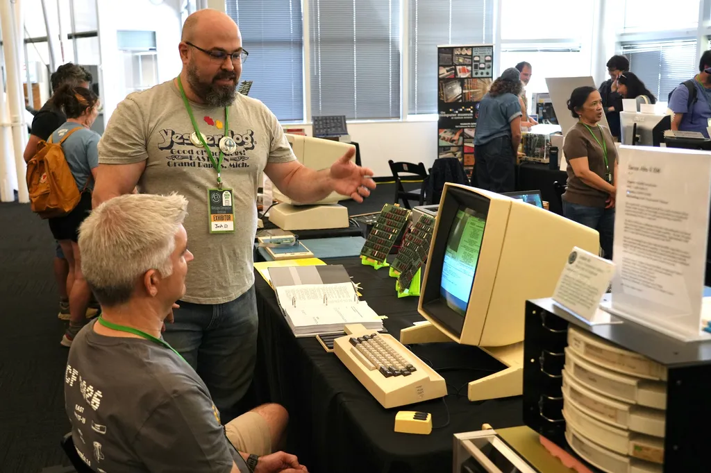 Software engineer Josh Dersch, standing, shows a 1970s Xerox Alto computer he restored at the Vintage Computer Festival in Mountain View, Calif.,