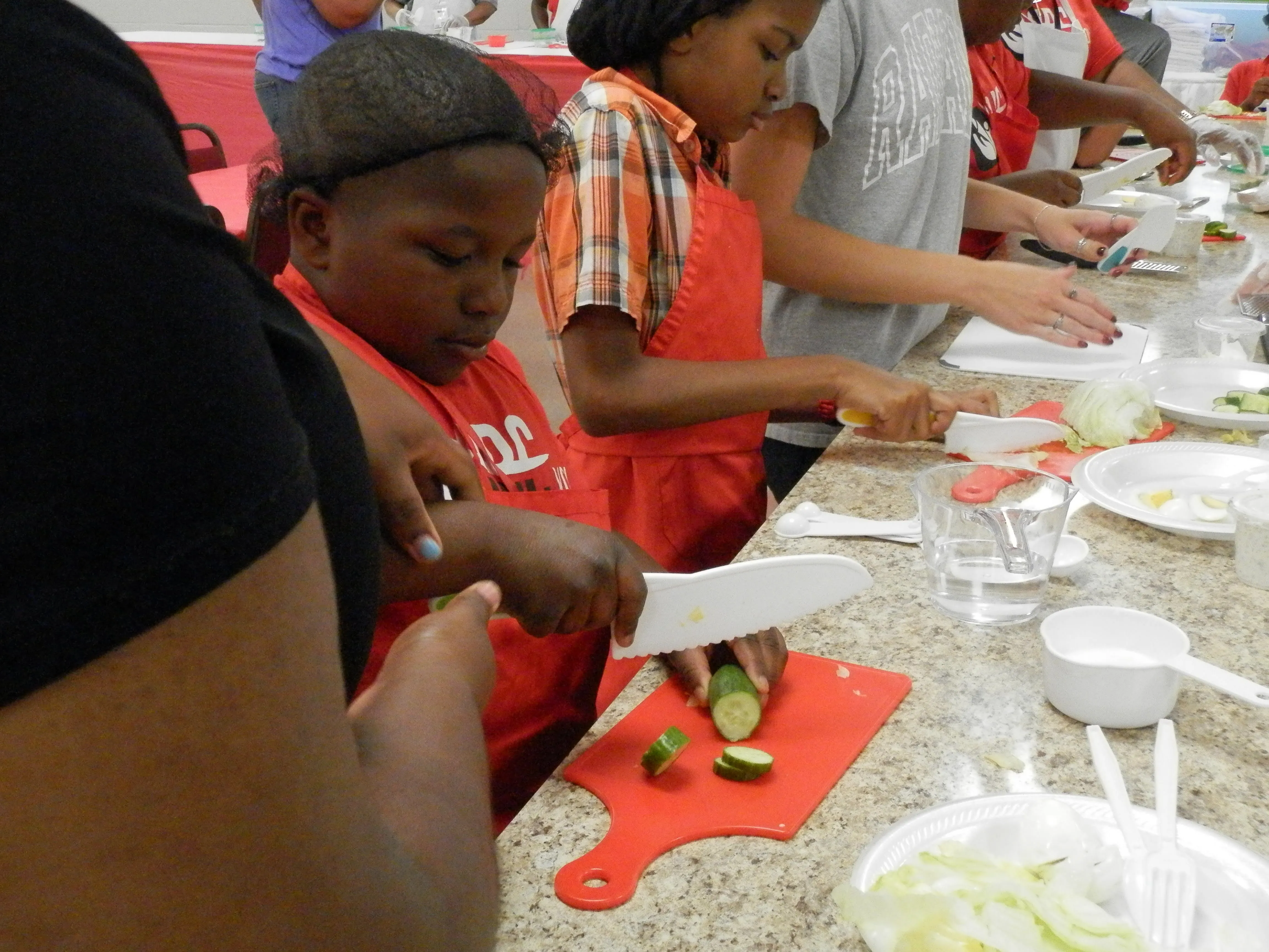 ABC Youth Cutting A Cucumber Practicing Culinary Arts