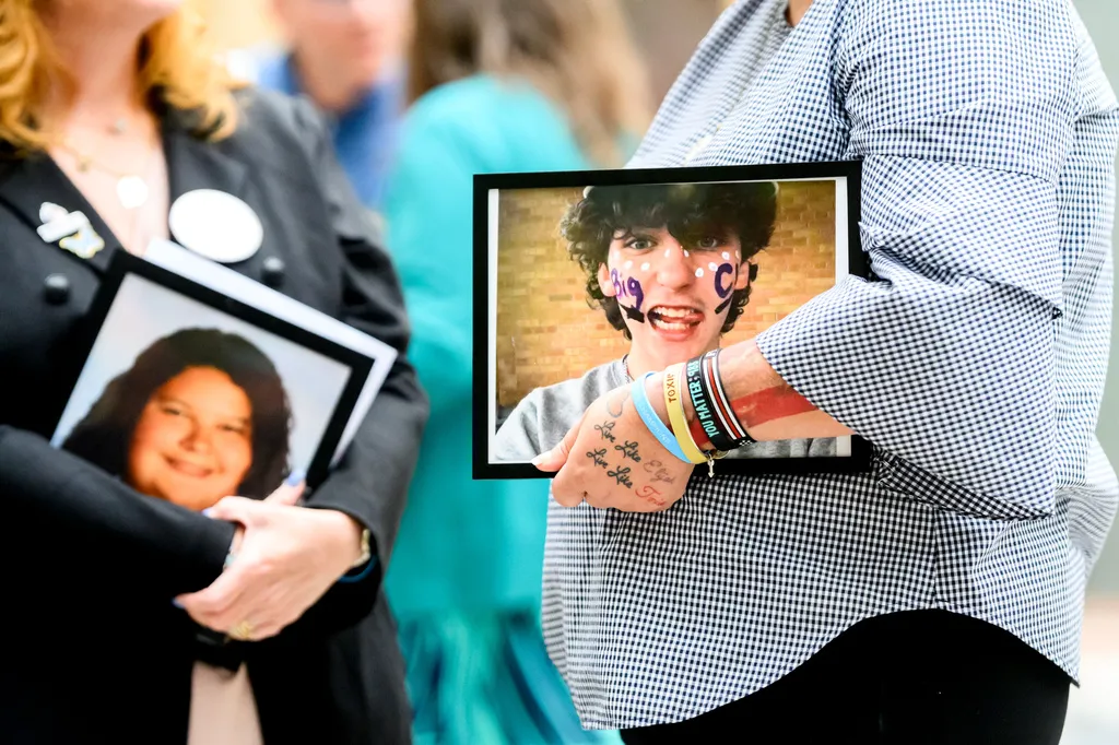Shannon Heacock holds a photo of son Elijah Heacock, who died at age 16