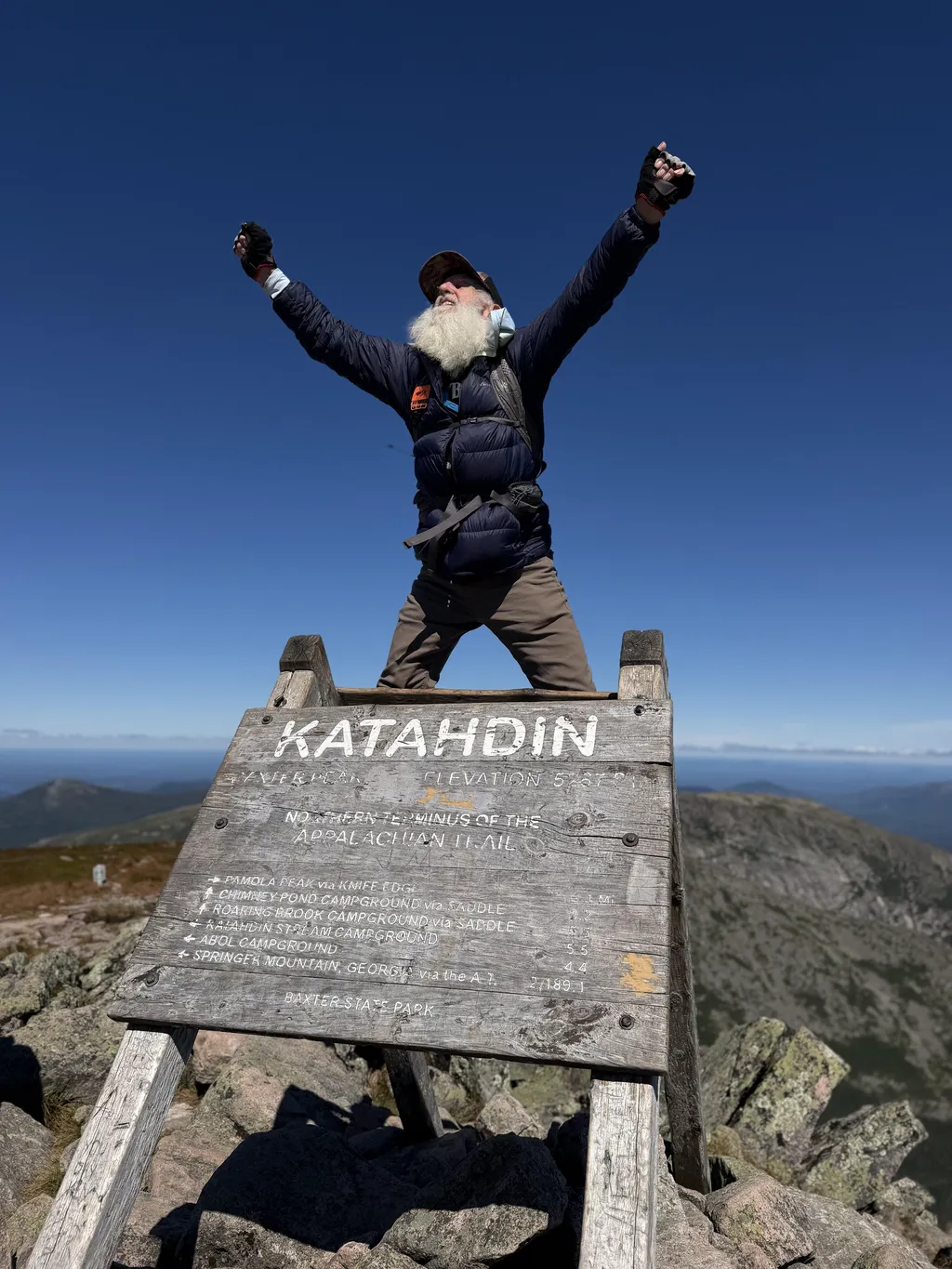Dale Sanders, 91, celebrates upon completing his hike of the Appalachian Trail at the summit of Mt. Katahdin