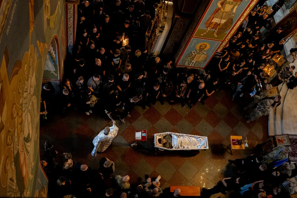 Relatives and friends mourn near the coffin of Ukrainian serviceman Danyil Smyrnov, 21, who was killed on the frontline
