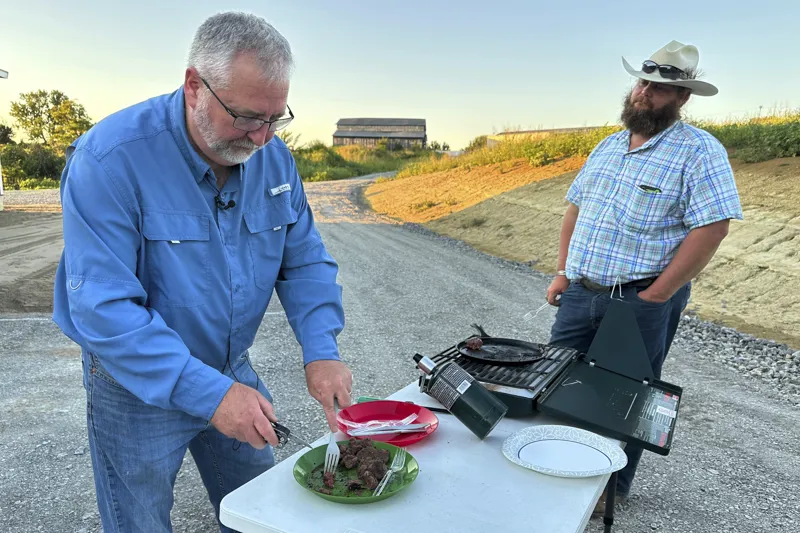 Brent Williams, an alpha gal syndrome sufferer, prepares ostrich meat with farm owner W.D. King in Danville, Ky.