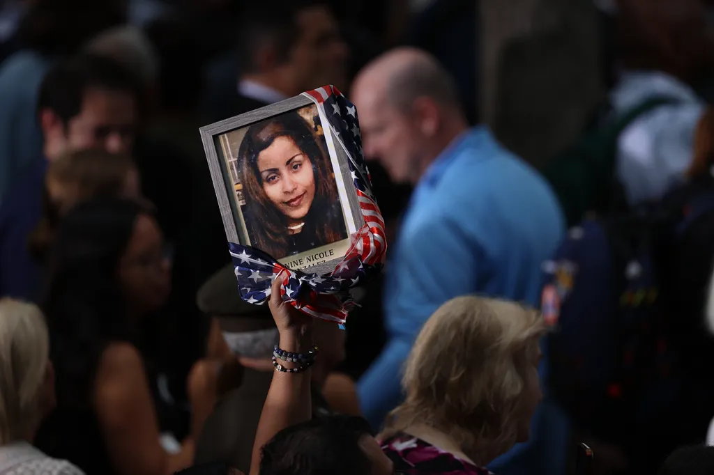 People attend a memorial on the 25th anniversary of the September 11, 2001, terrorist attacks