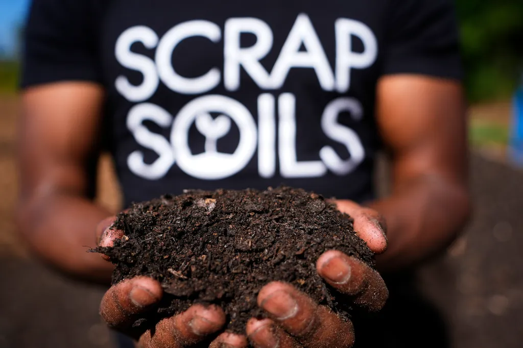 Ricky Blanding, founder of Scrap Soils, holds composted soil at Sanctuary Farms