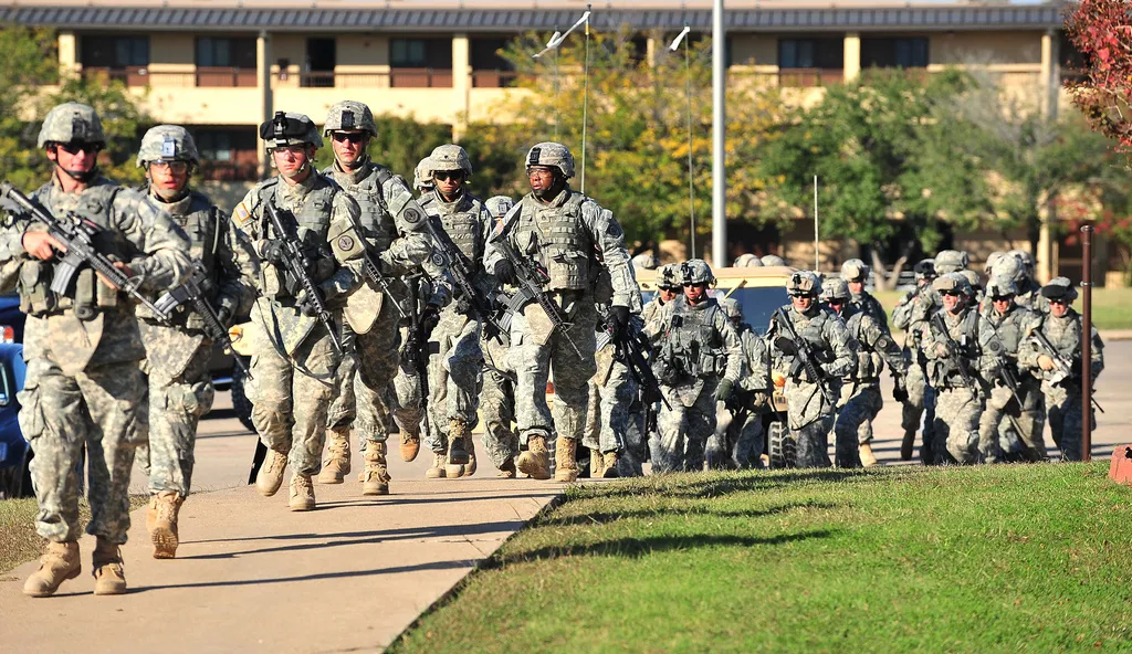 Soldiers from the 3rd Armored Cavalry Regiment storm the grounds of the Soldier Readiness Center to apprehend a mass shooter in Fort Hood, Texas, on Nov. 5, 2009