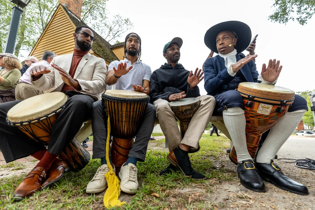 People drum during a community-wide rededication ceremony of the reconstructed African Baptist Meeting House, now known as First Baptist Church of Williamsburg