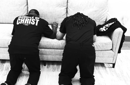 Two men kneeling in prayer