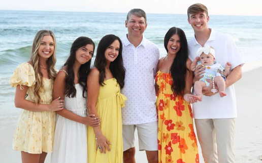 Husband and wife, three daughters, son-in-law and baby on beach