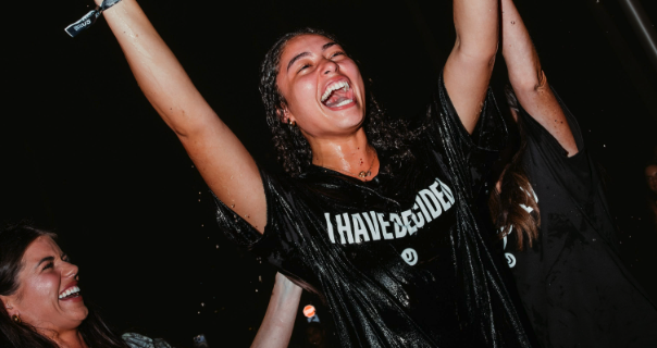 Young woman smiling with arms in the air, wearing a t-shirt "I have decided"