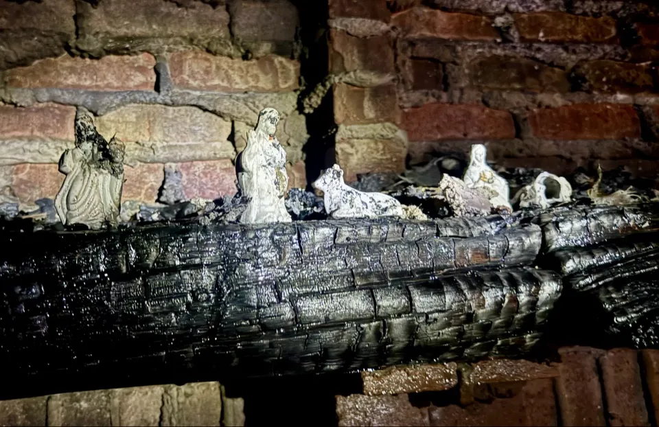 Nativity scene, charred, but standing
