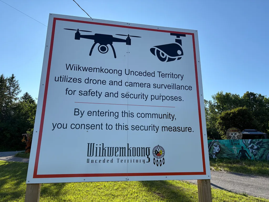 A sign warns visitors to the First Nations community of Wiikwemkoong that they could be monitored