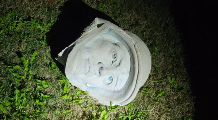 The decapitated head of one of the statues in the memorial