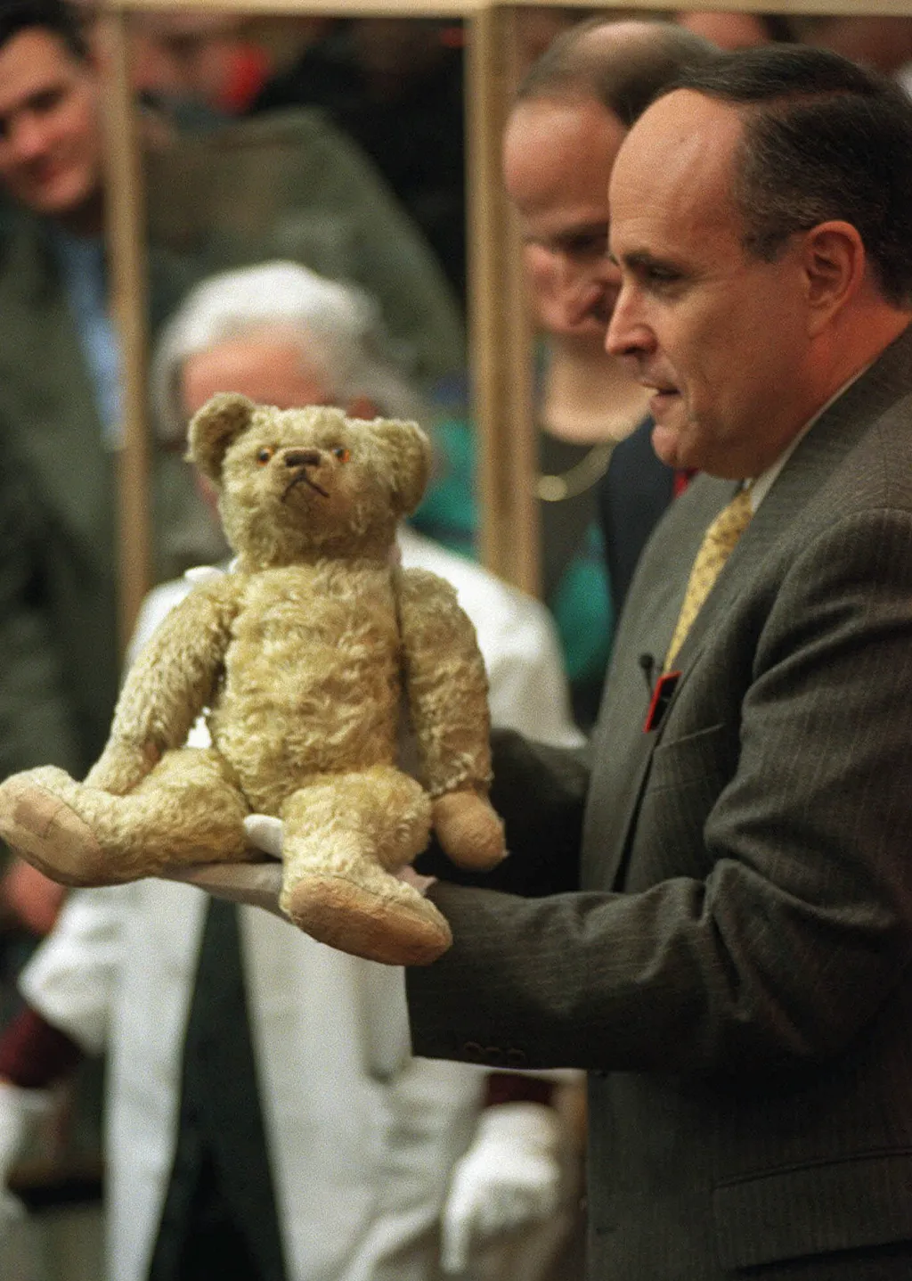 (1998) New York Mayor Rudolph Giuliani, wearing gloves, holds the original stuffed Winnie the Pooh bear