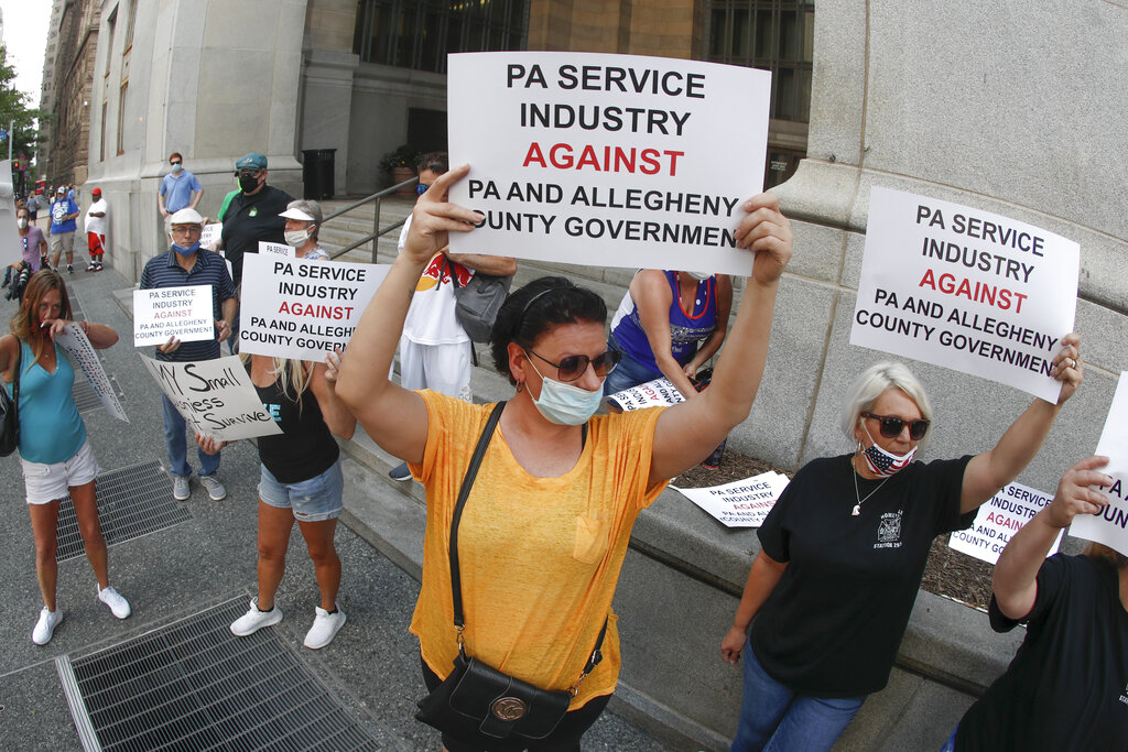 Service Industry workers and supporters hold protest signs in front of Allegheny County offices in Pittsburgh