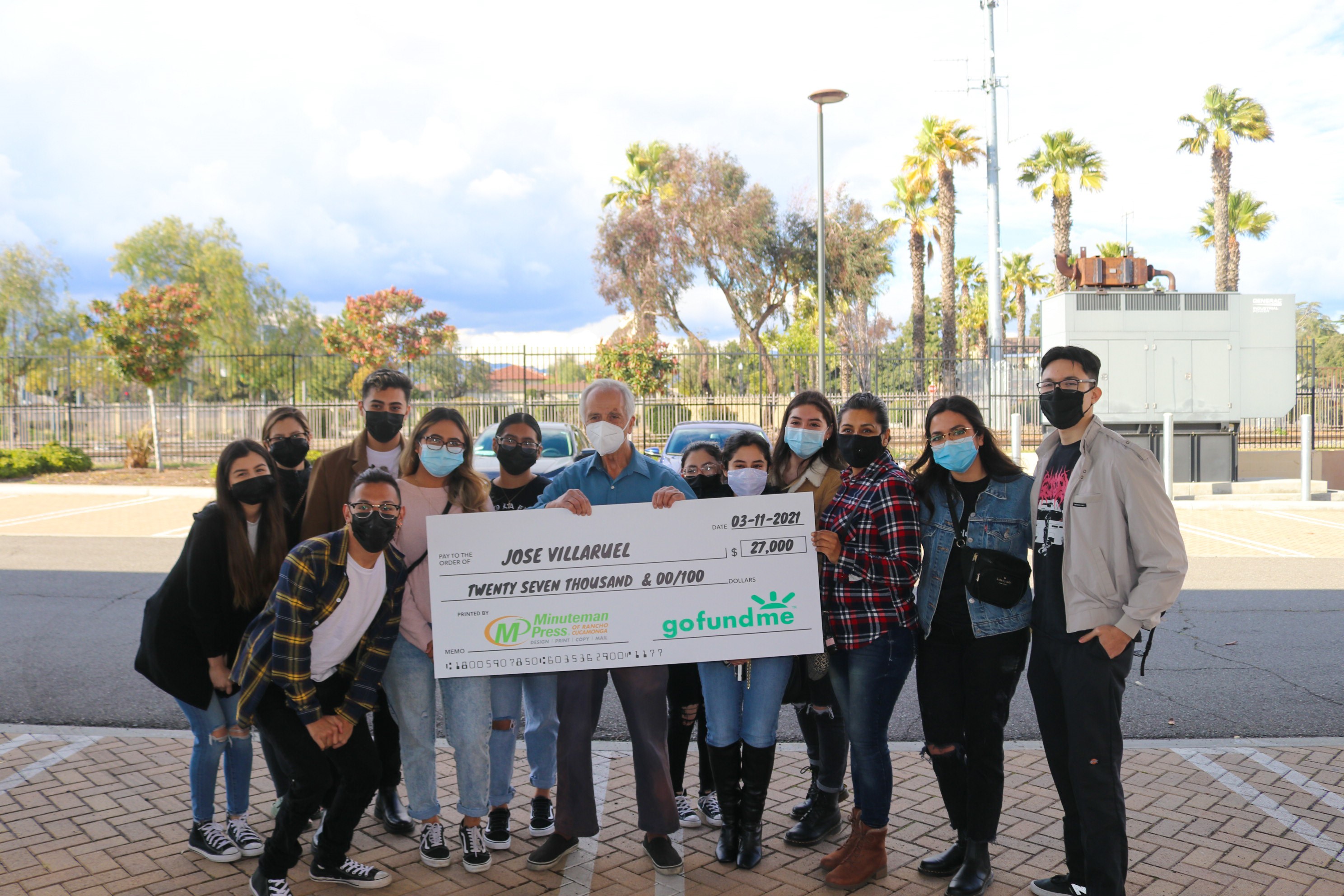 Community presents donation check to former substitute teacher Mr. V