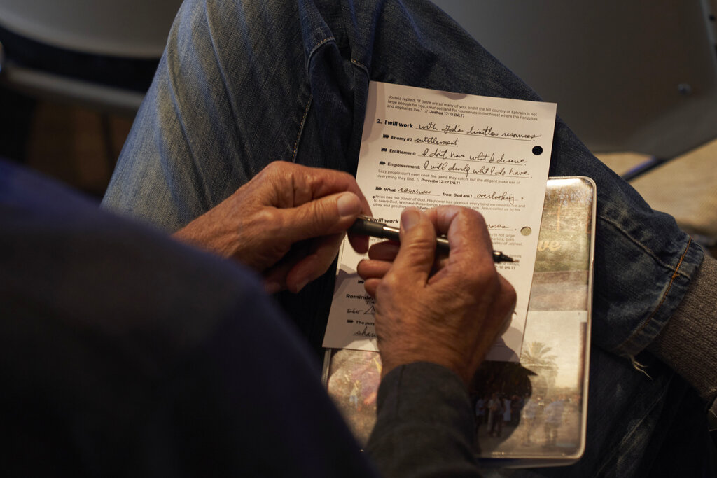 Person takes sermon notes at Saddleback church