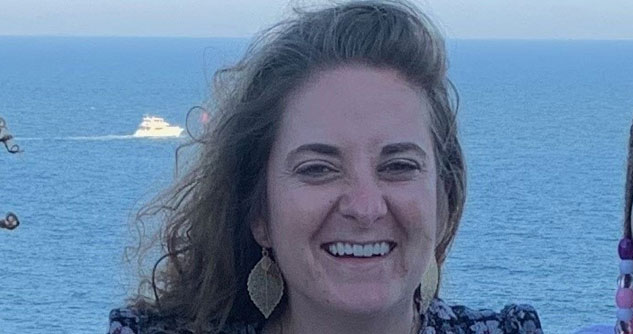 Woman with ocean in background, smiling