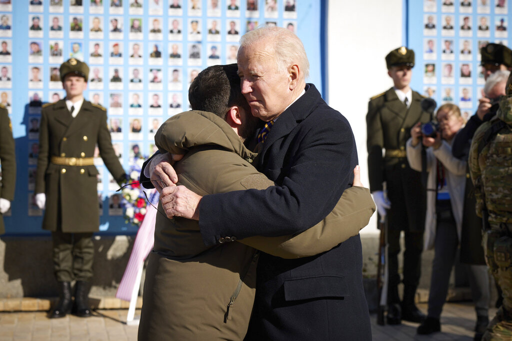 President Biden and Ukrainian President Zelenskyy hug as they say goodbye at the Memorial Wall of Fallen Defenders of Ukraine