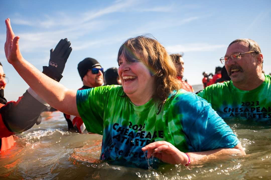 Lots of people high-fiving others in the ocean