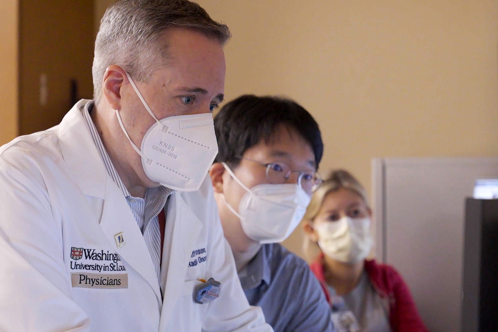 Dr. Clifford Robinson works with others during an experimental treatment using radiation on the heart of Jeff Backus in St. Louis