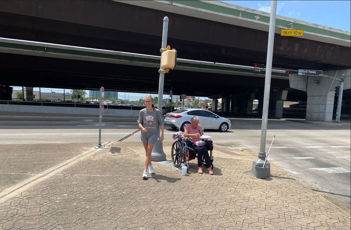 Hope Beyond Bridges volunteer feeding person in a wheelchair