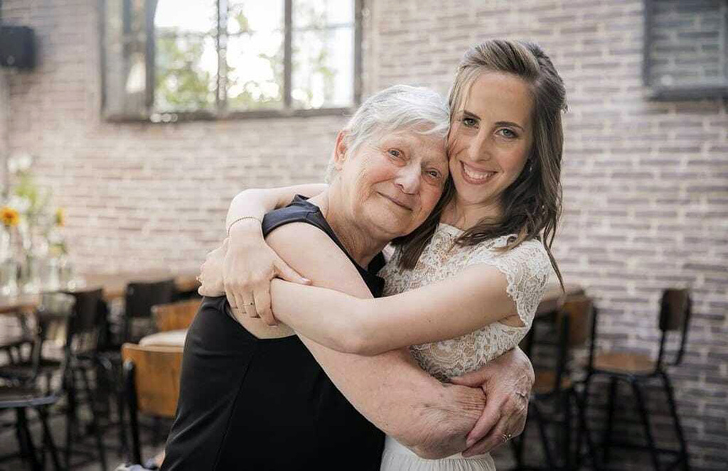 Yaffa Adar, left, hugs her granddaughter Adva Adar during her wedding, in 2021. Yaffa Adar is the elderly woman the world saw being driven by Hamas militants in a golf cart.