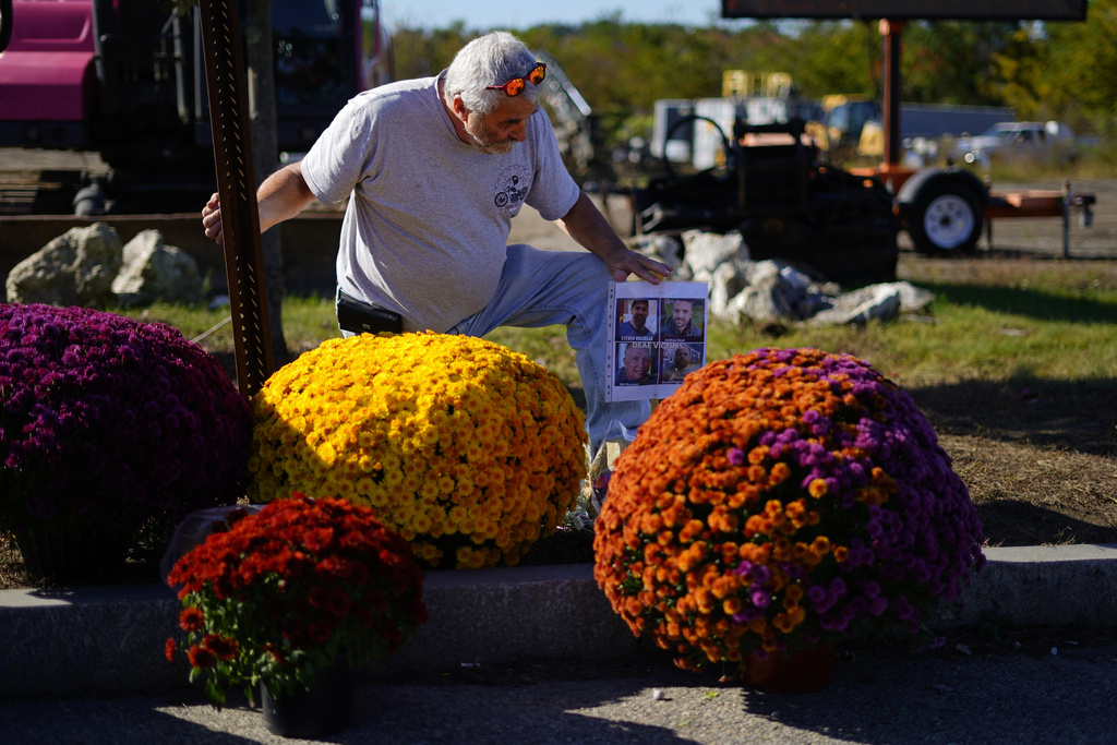 Richard Morlock, a member of the deaf community and surviver of the mass shooting at Schemengees Bar and Grille, pays his respect at a makeshift memorial to his friends he played cornhole with who were killed during the recent mass shooting