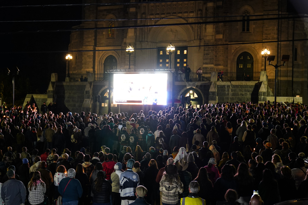 People gather at a vigil for the victims of Wednesday