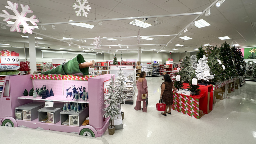 Shoppers look over holiday merchandise on display at a Target store in Orlando