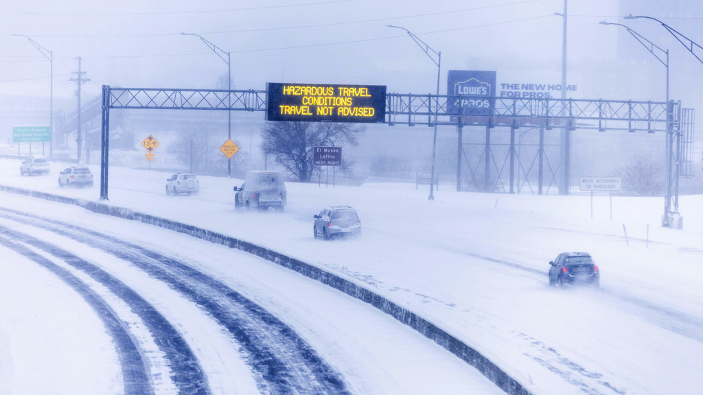 Signs along US Highway 75, looking south from F Street, advise against travel due to snow in Omaha
