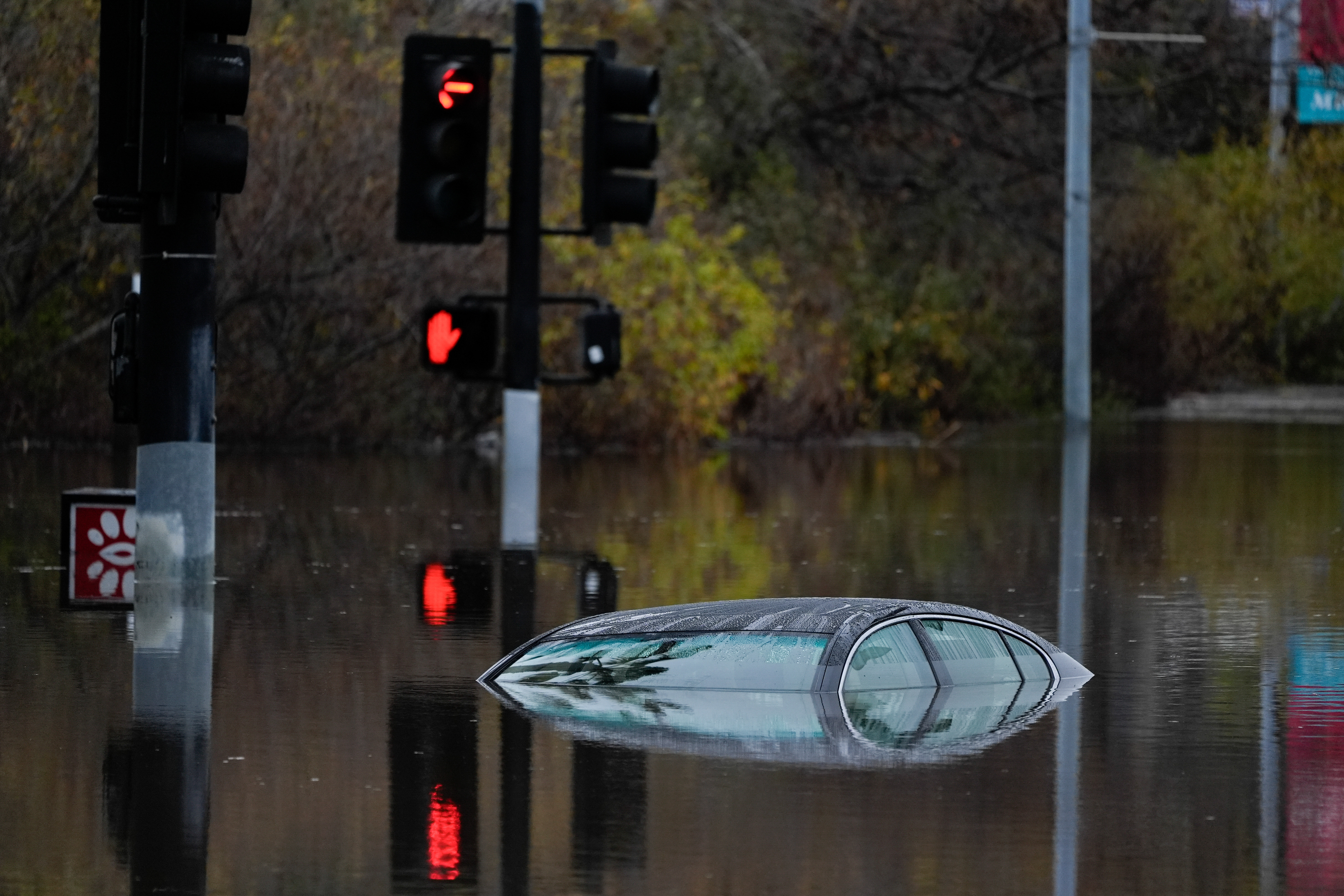 The very top of a car surrounded by floodwater