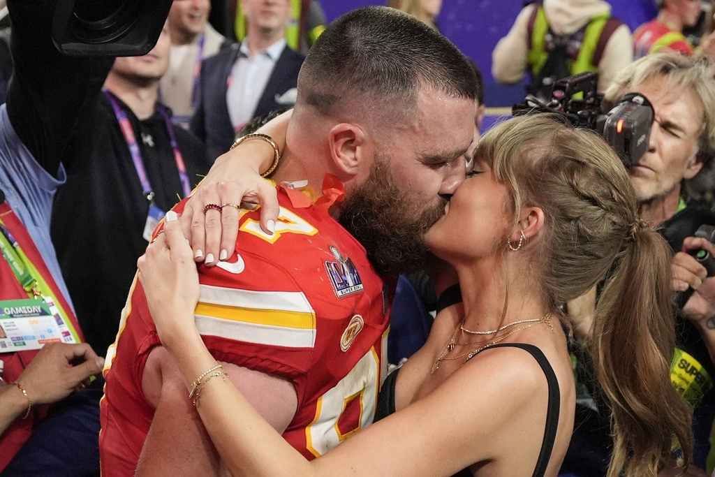 Kansas City Chiefs tight end Travis Kelce (87) kisses Taylor Swift after the NFL Super Bowl 58 football game 