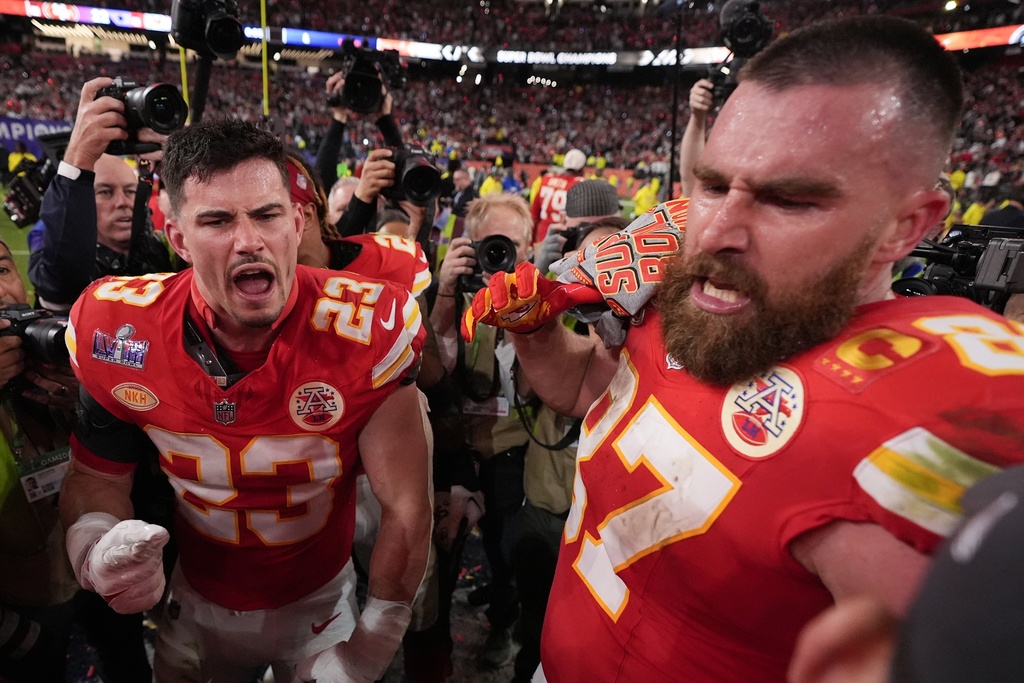 Kansas City Chiefs tight end Travis Kelce (87) and Kansas City Chiefs linebacker Drue Tranquill (23) celebrate after the NFL Super Bowl 58 