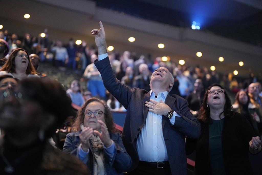 Churchgoers sing during a service at Lakewood Church