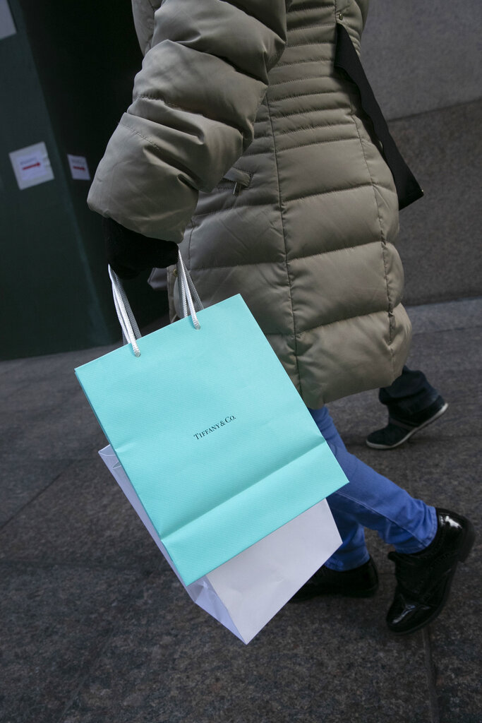 A customer carries her Tiffany bag