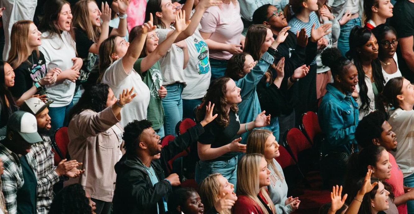 Young people with hands raised
