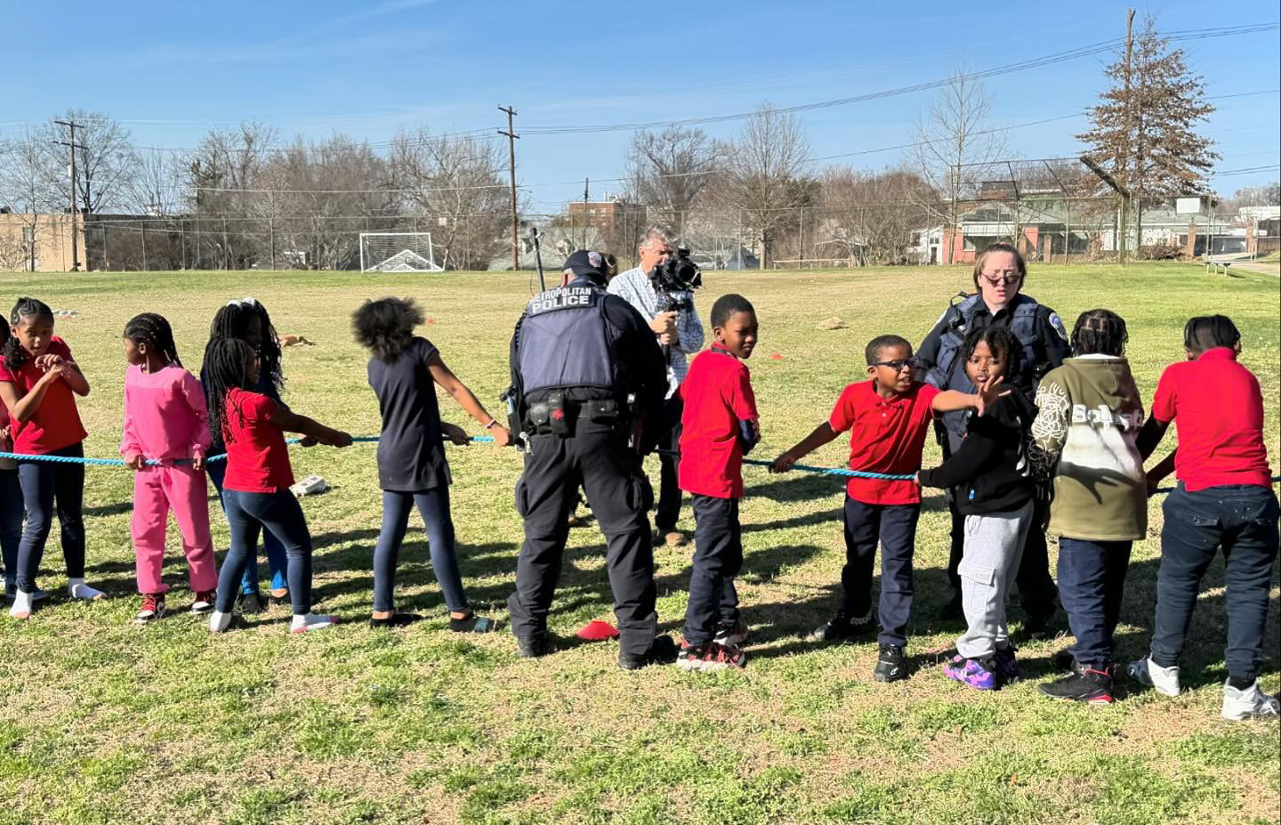 Children and police playing tug-of-war
