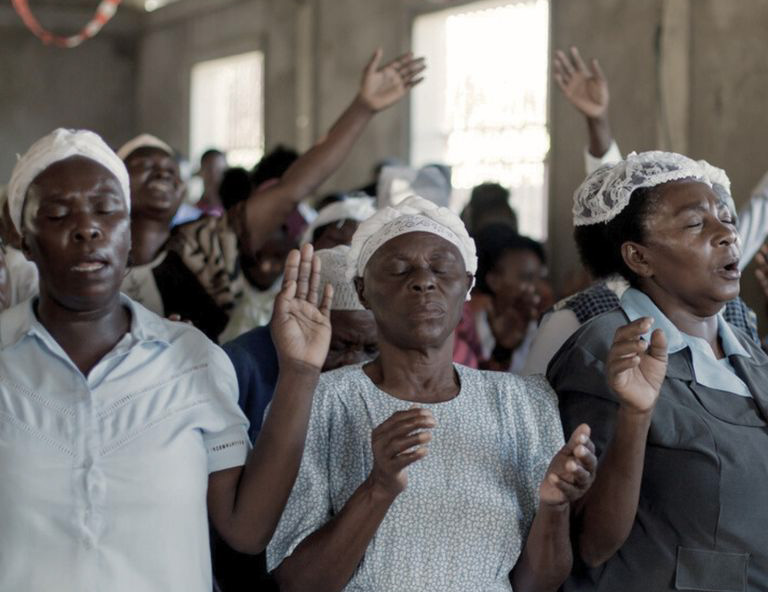 Women with eyes closed, praying