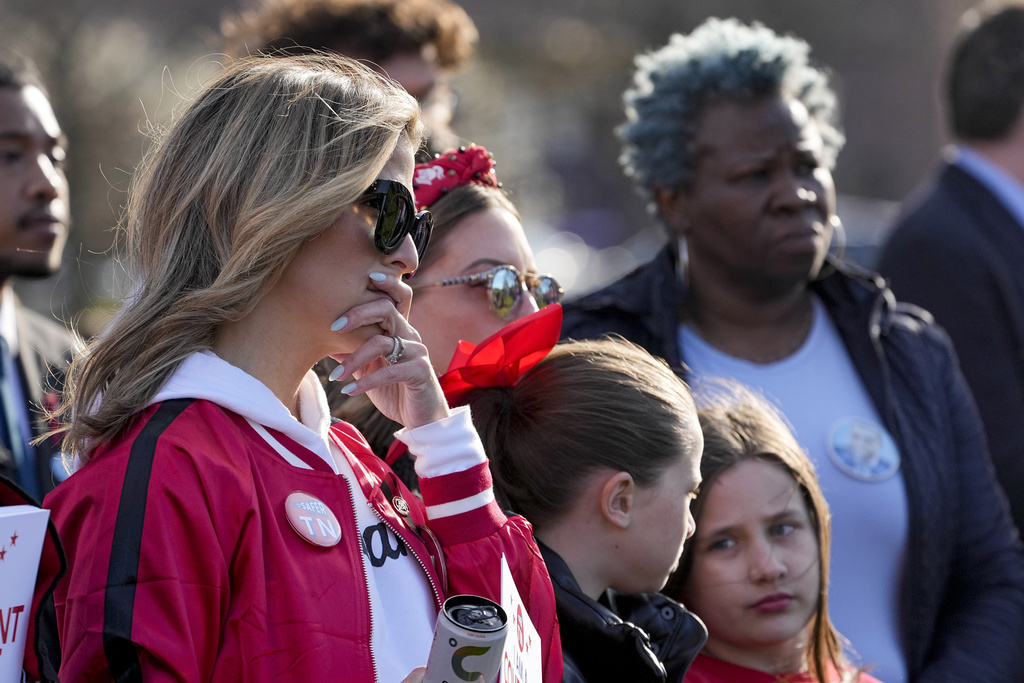 Covenant School mother Mary Joyce, left, attends the Linking Arms for Change human chain