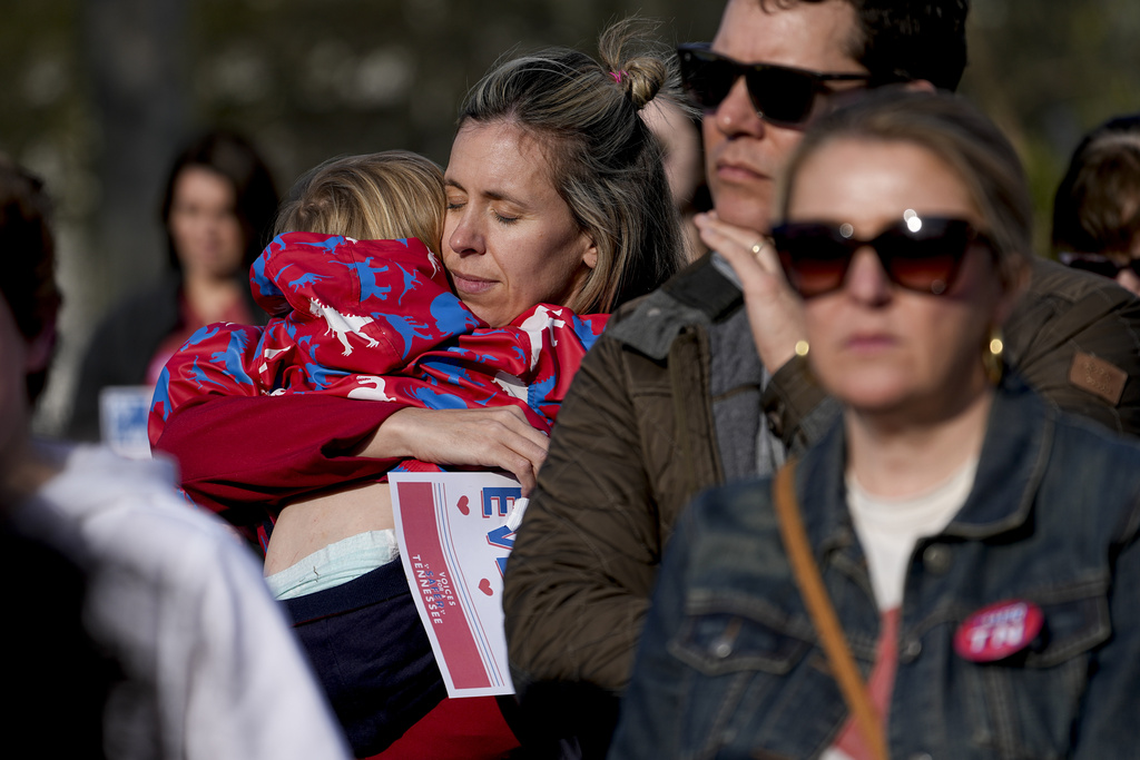 Grace Dent hugs her son Jack, 2, during the Linking Arms for Change human chain