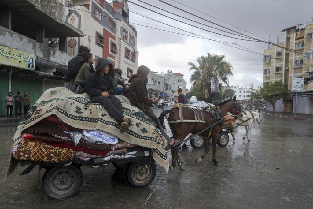 Palestinians flee from the eastern side of the southern Gaza city of Rafah after the Israeli army orders them to evacuate ahead of a announced military operation, in Rafah, Gaza Strip